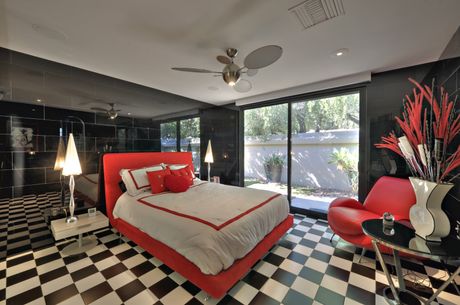 red and white bed with black and white flooring