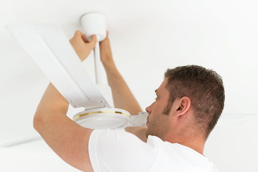 man installing the ceiling fan