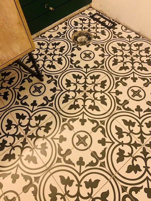 Black and white patterned tiles on a floor.