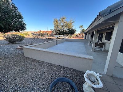 A house with a patio and a statue in front of it.