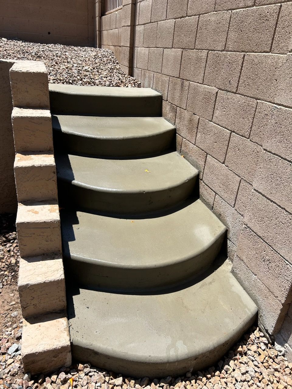 A house with a concrete sidewalk in front of it
