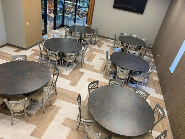 A large room with tables and chairs in it