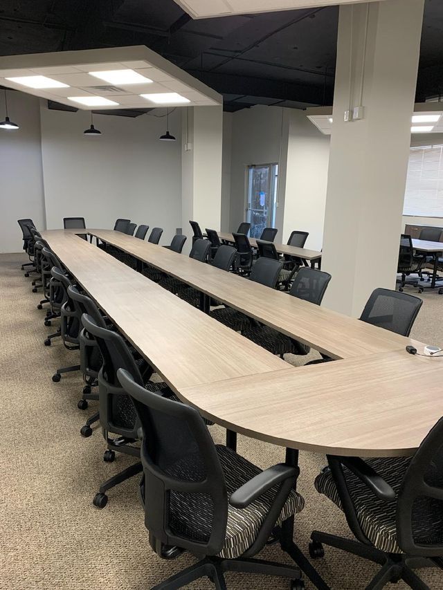 A conference room with a long table and chairs