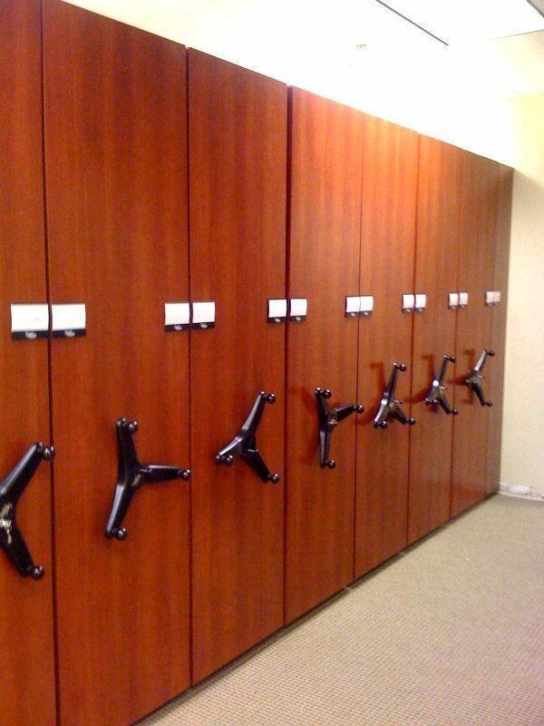 A row of wooden lockers with black handles