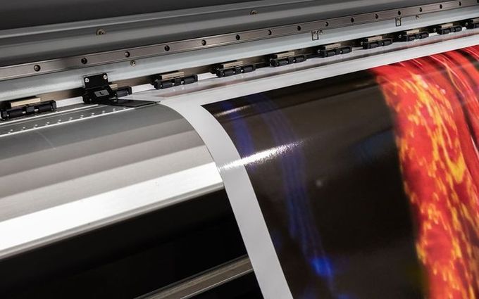 A large poster is being printed on a large printer.