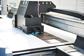 A large printing machine is sitting on top of a table.