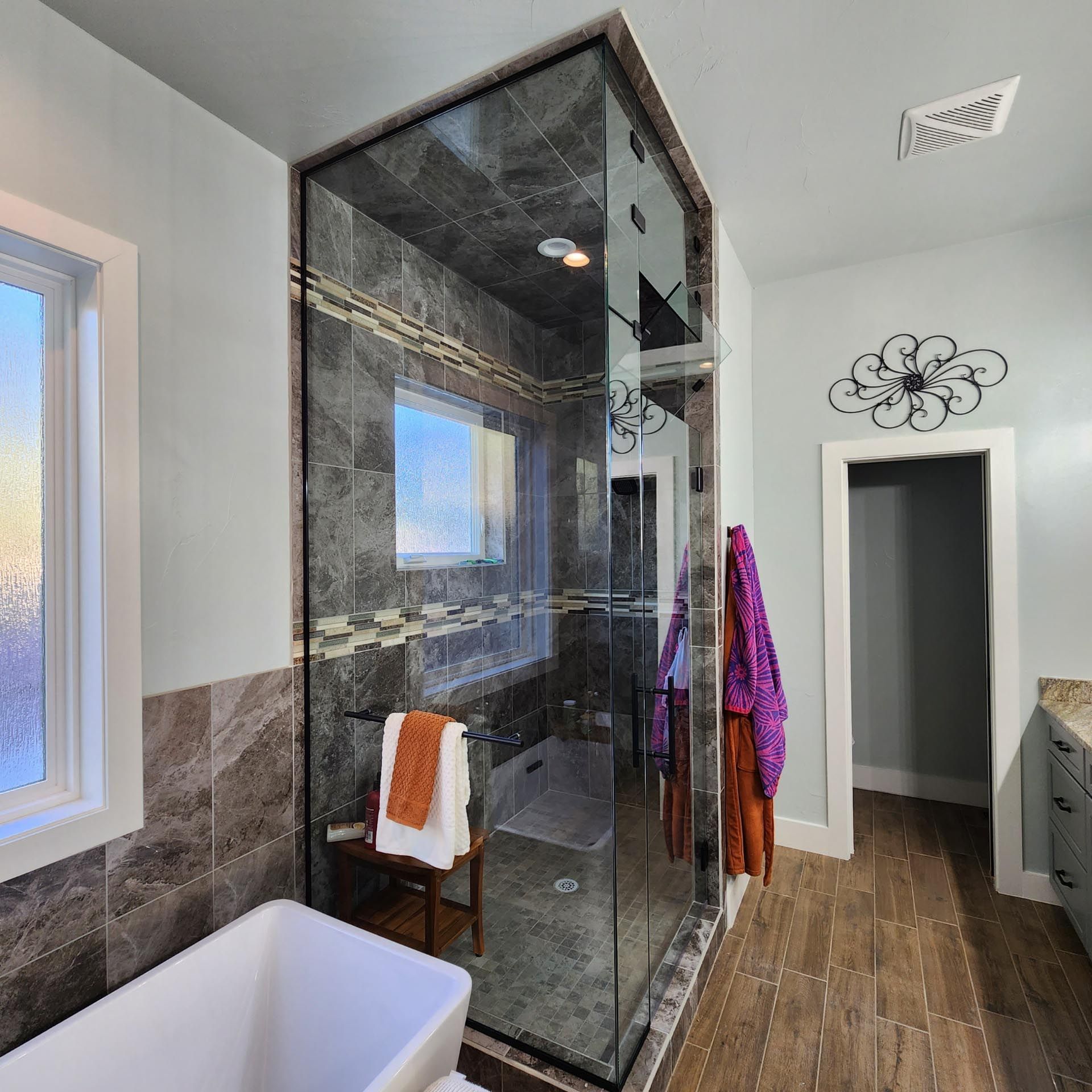 A bathroom with a tub and a walk in shower