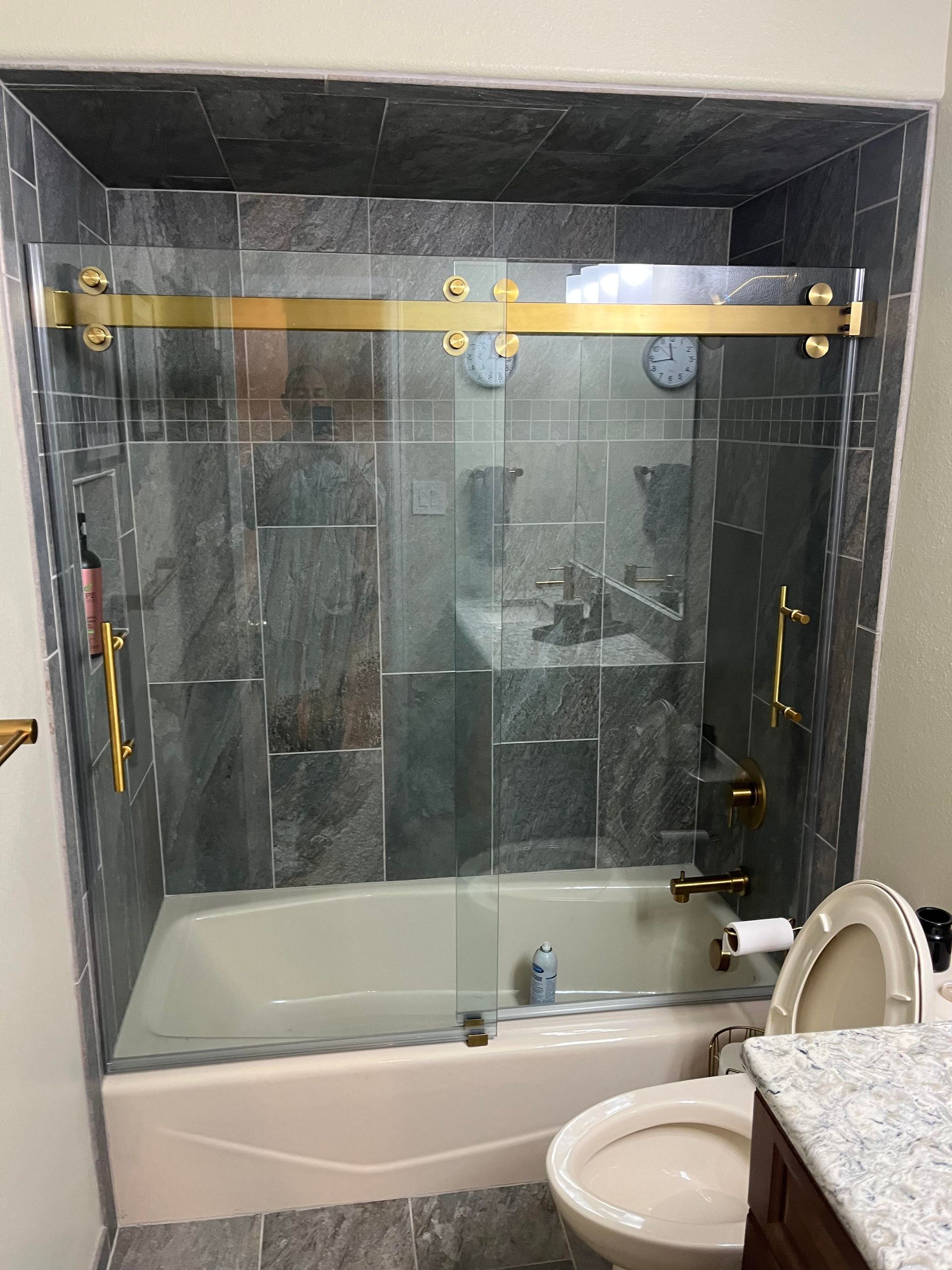 A bathroom with a bathtub , toilet and sink.