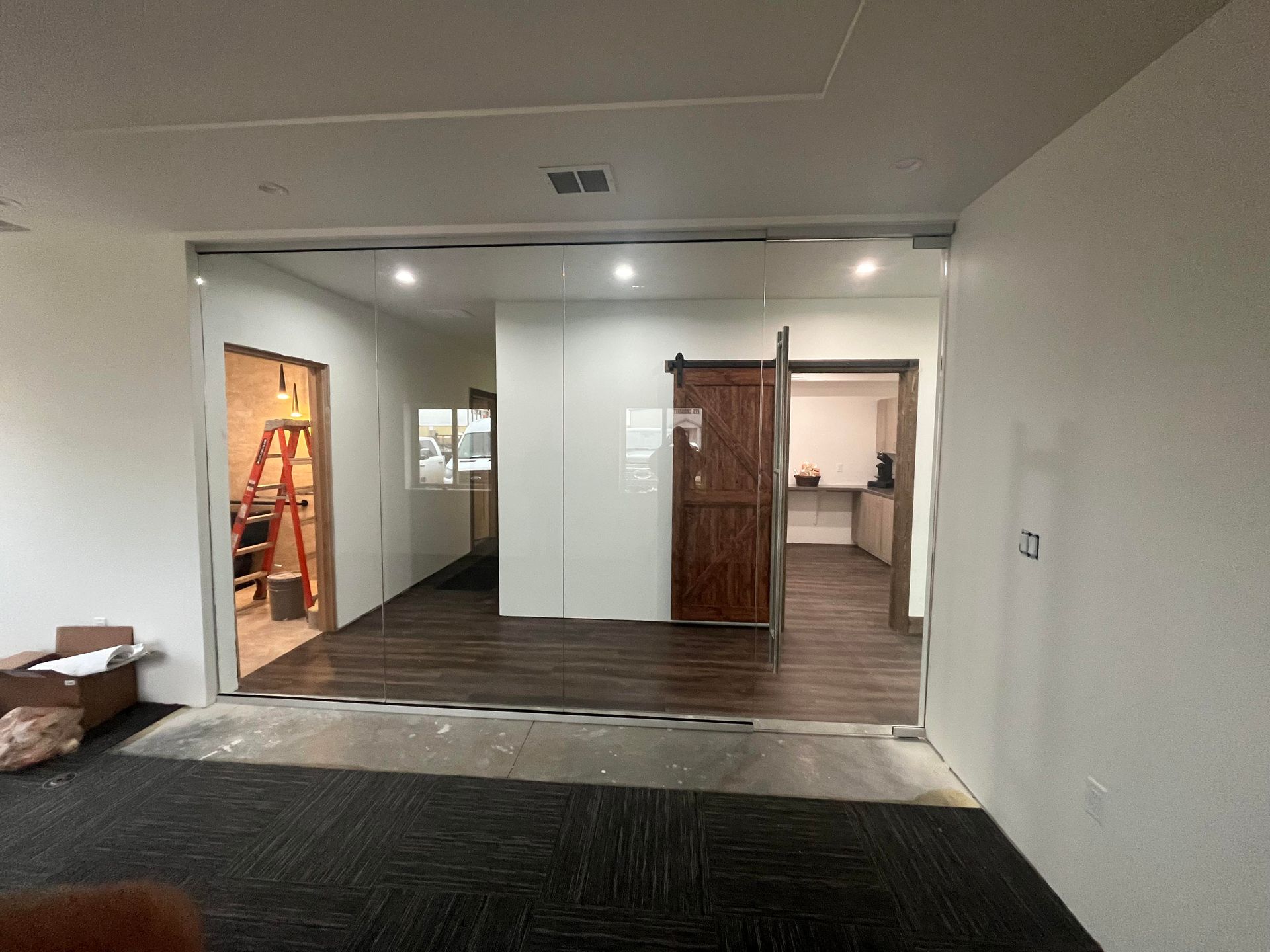 A room with a sliding glass door and a wooden floor.