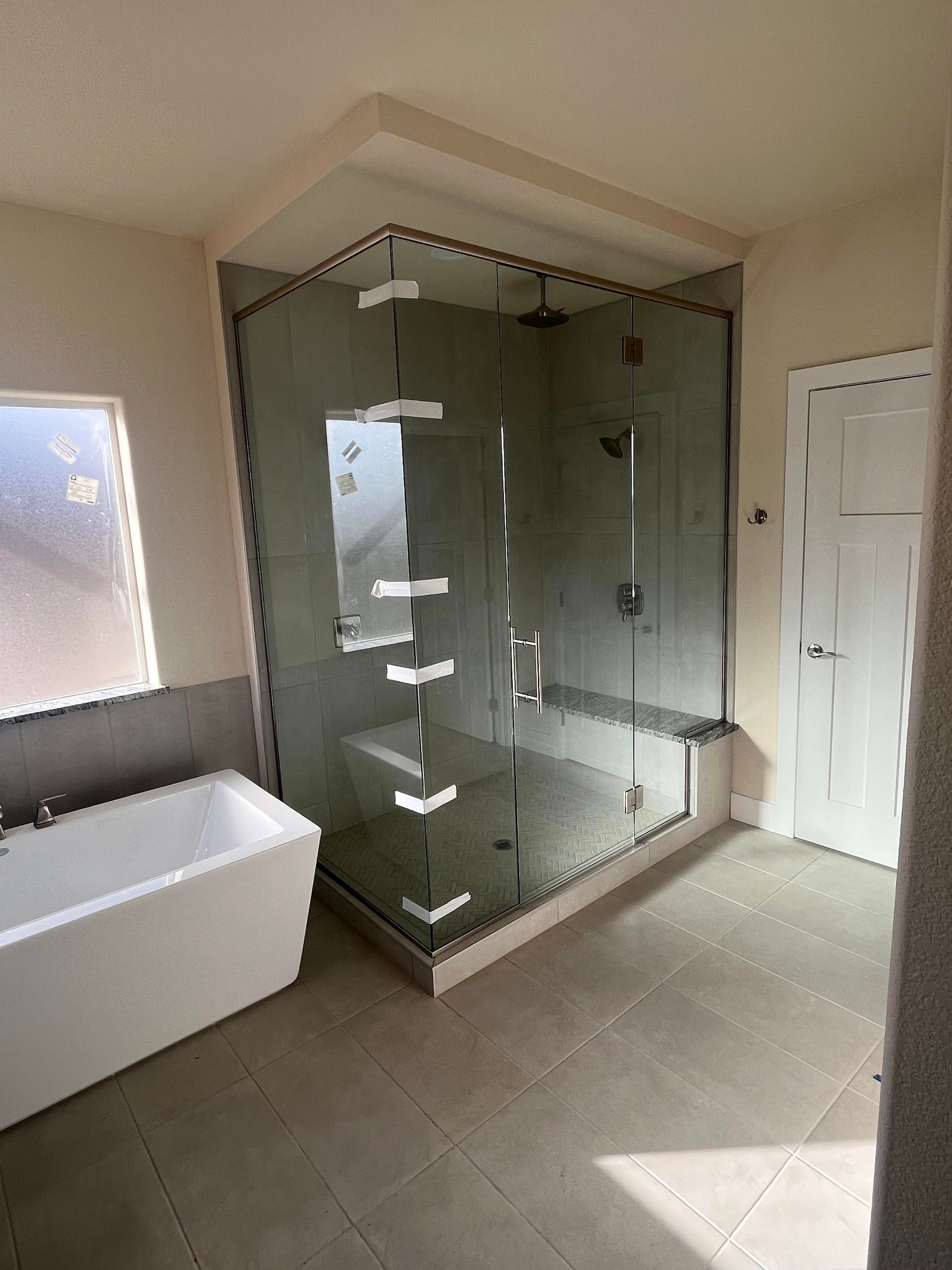 A bathroom with a bathtub and a walk in shower.