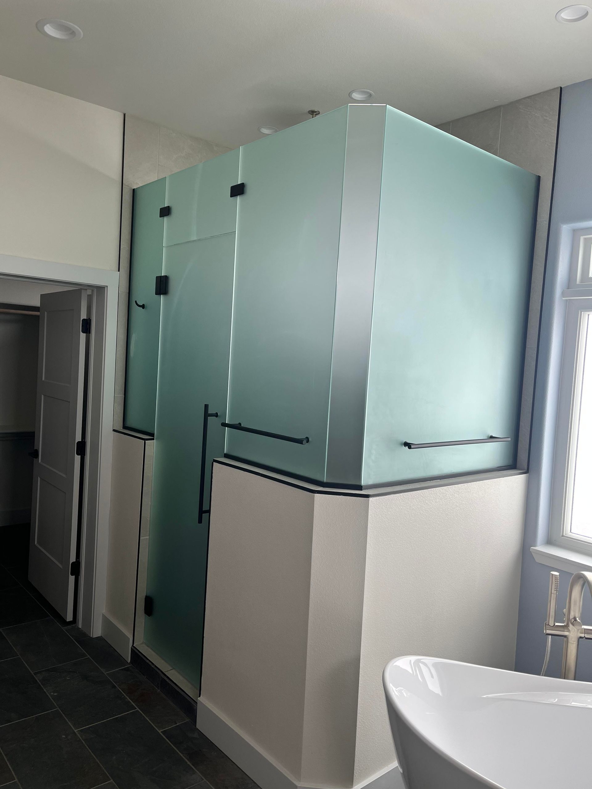 A bathroom with a bathtub and a shower stall