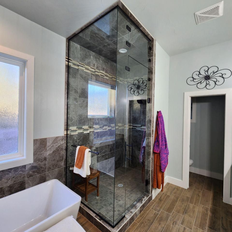 A bathroom with a bathtub and a walk in shower