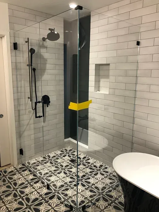 A bathroom with a walk in shower and a bathtub.