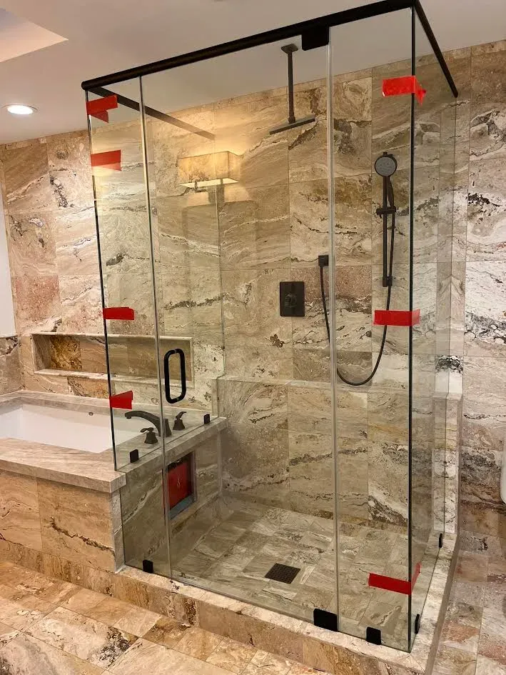 A bathroom with a walk in shower and a bathtub.