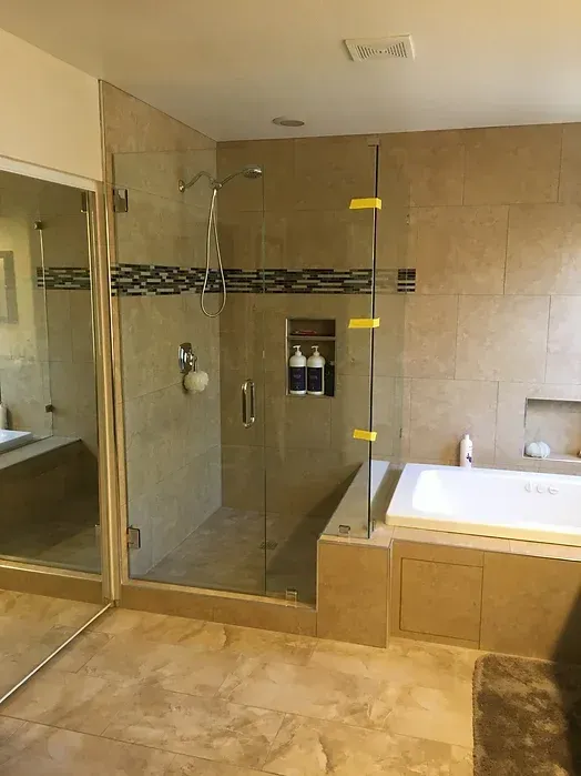 A bathroom with a walk in shower and a bathtub.