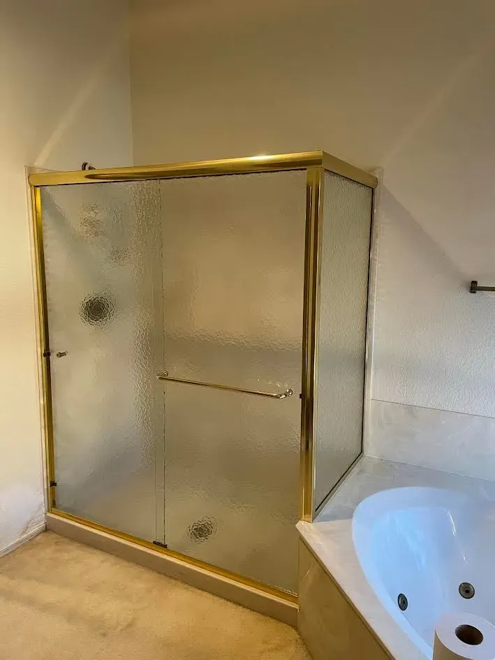 A bathroom with a walk in shower and a bathtub.