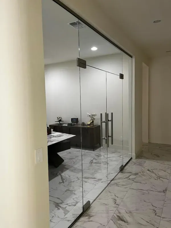 A room with a glass wall and marble floor.