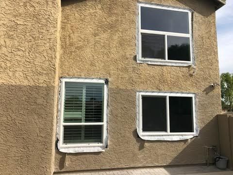 A house with a lot of windows on the side of it.