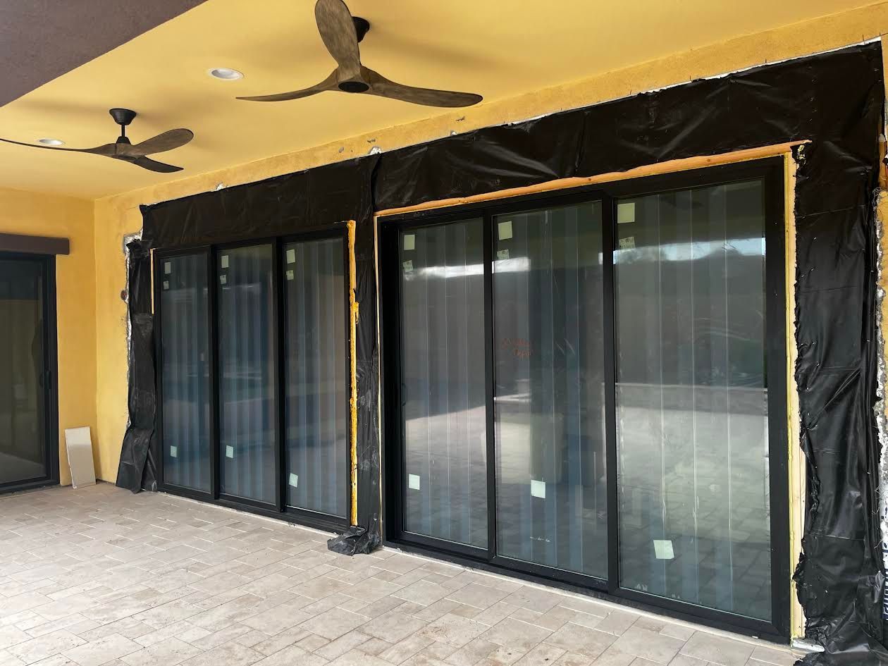 A patio with sliding glass doors and ceiling fans