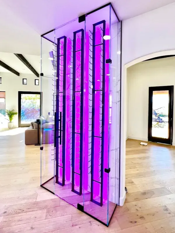 A wine rack with purple lights in a living room