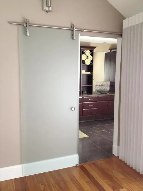 A sliding glass door opens to a kitchen