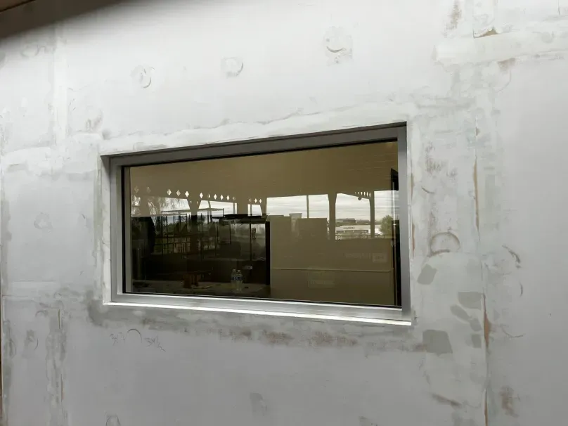 There is a large window in the wall of a building.