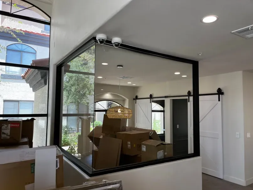 A room with a large window and a sliding barn door.