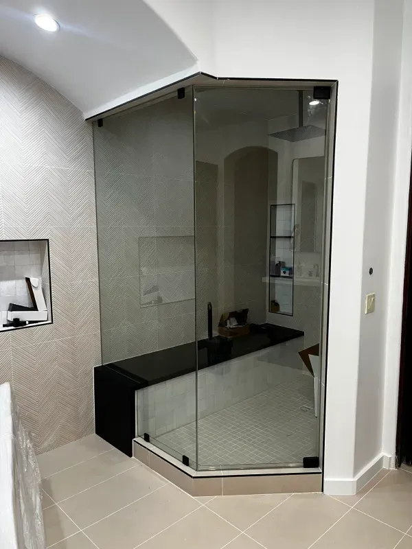 A bathroom with a walk in shower and a bathtub.