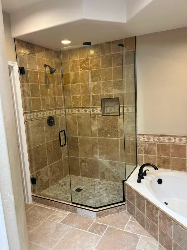 A bathroom with a walk in shower and a bathtub.