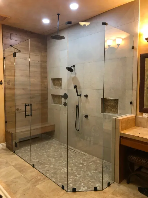 A bathroom with a walk in shower and a sink.