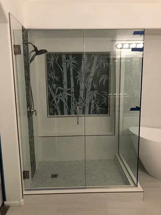 A bathroom with a walk in shower with a window and a tub.