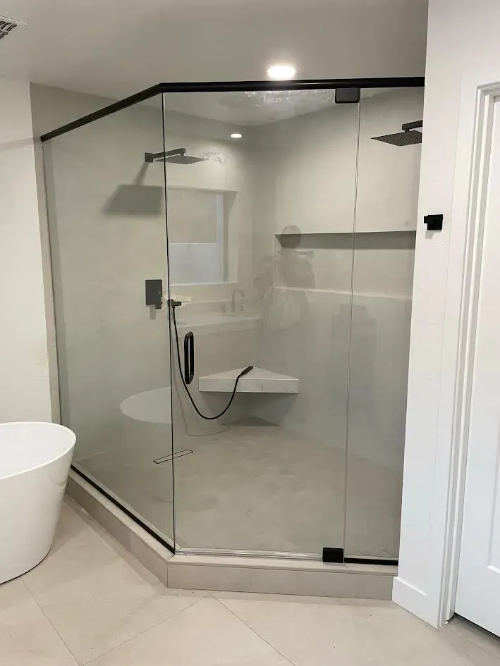 A bathroom with a walk in shower and a bathtub.