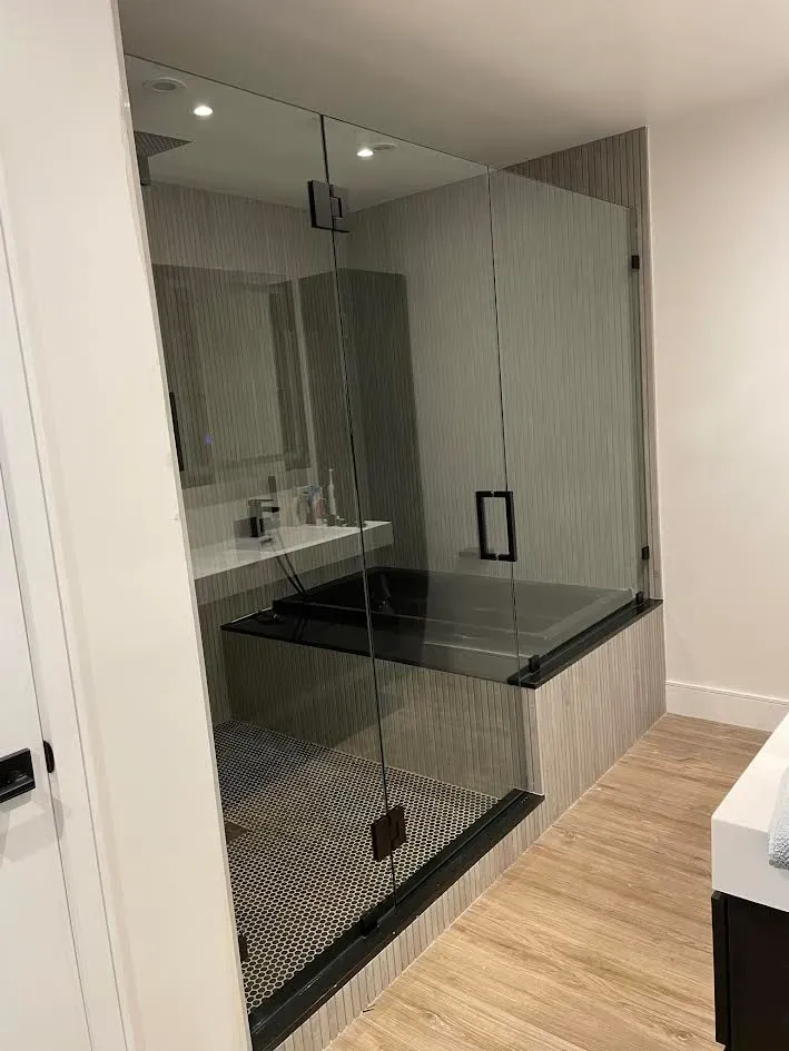 A bathroom with a walk in shower and a bathtub.