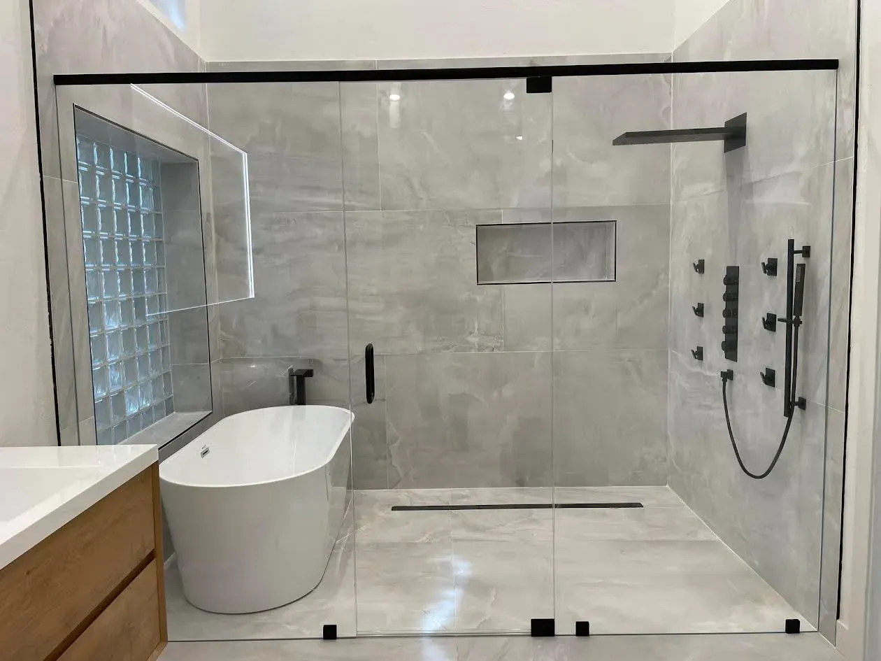 A bathroom with a bathtub and a walk in shower.