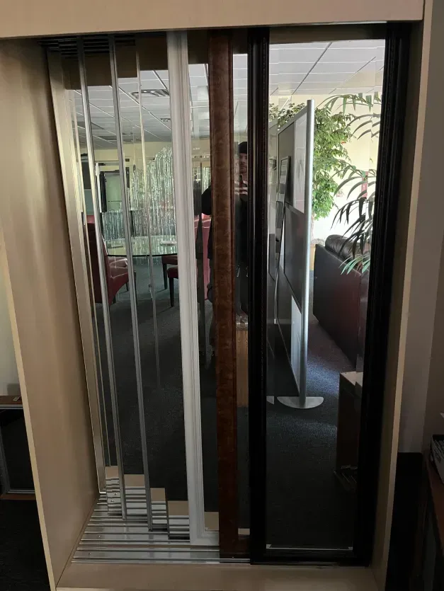 A sliding glass door is displayed in a room.