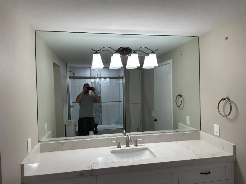 A man is taking a picture of himself in a bathroom mirror.