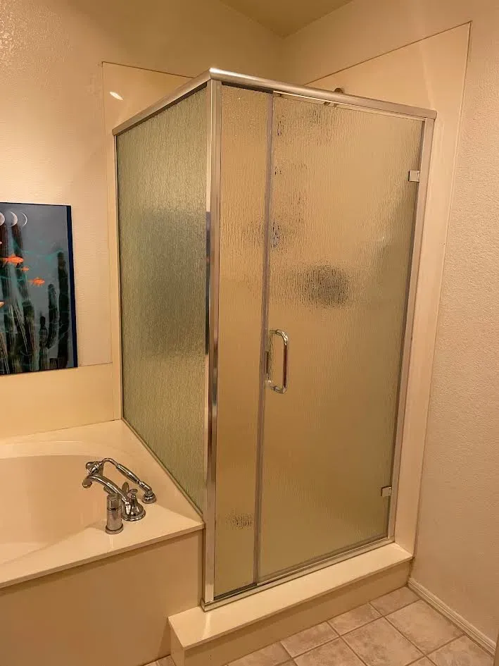 A bathroom with a bathtub and a shower stall.