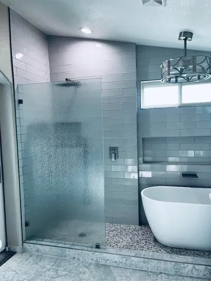 A bathroom with a bathtub and a walk in shower.