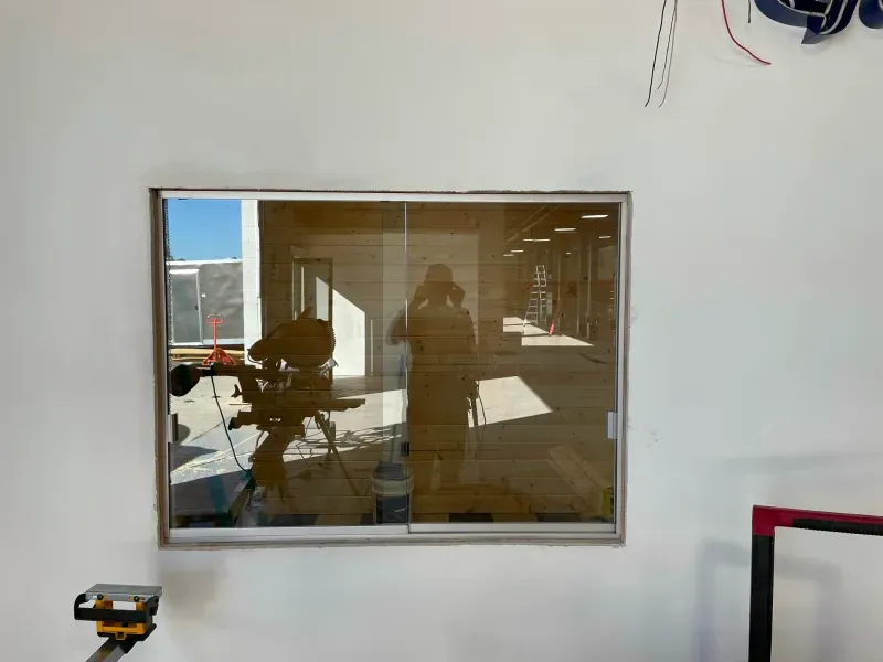 A man is taking a picture of himself in a window.