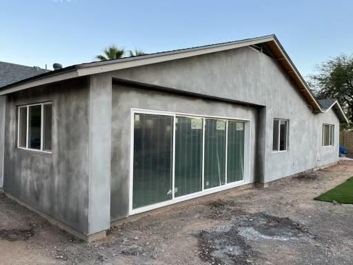 A house is being built with sliding glass doors and windows.