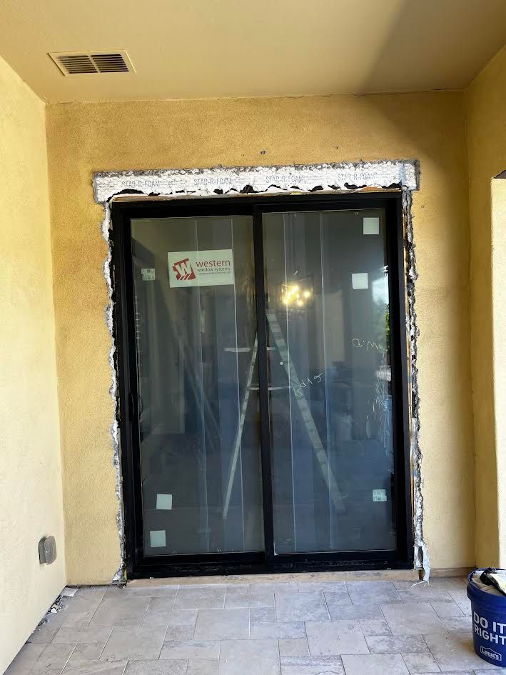 A sliding glass door is being installed in a house.
