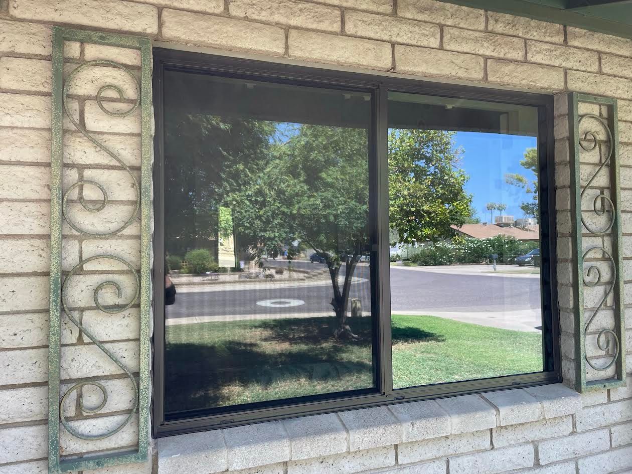 A brick building with a sliding glass door and a window