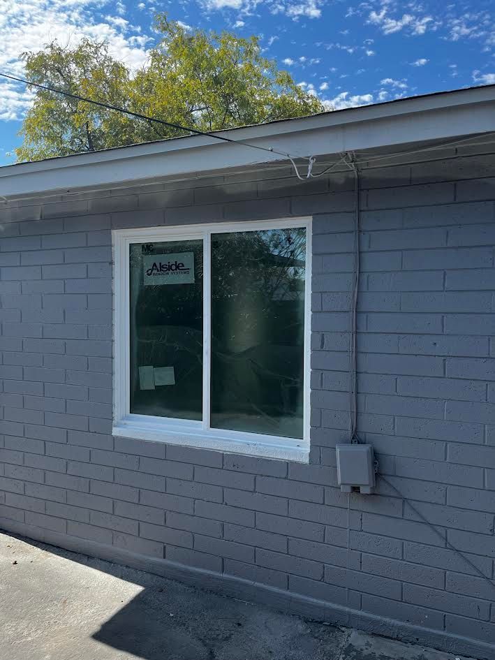 A brick building with a window on the side of it.