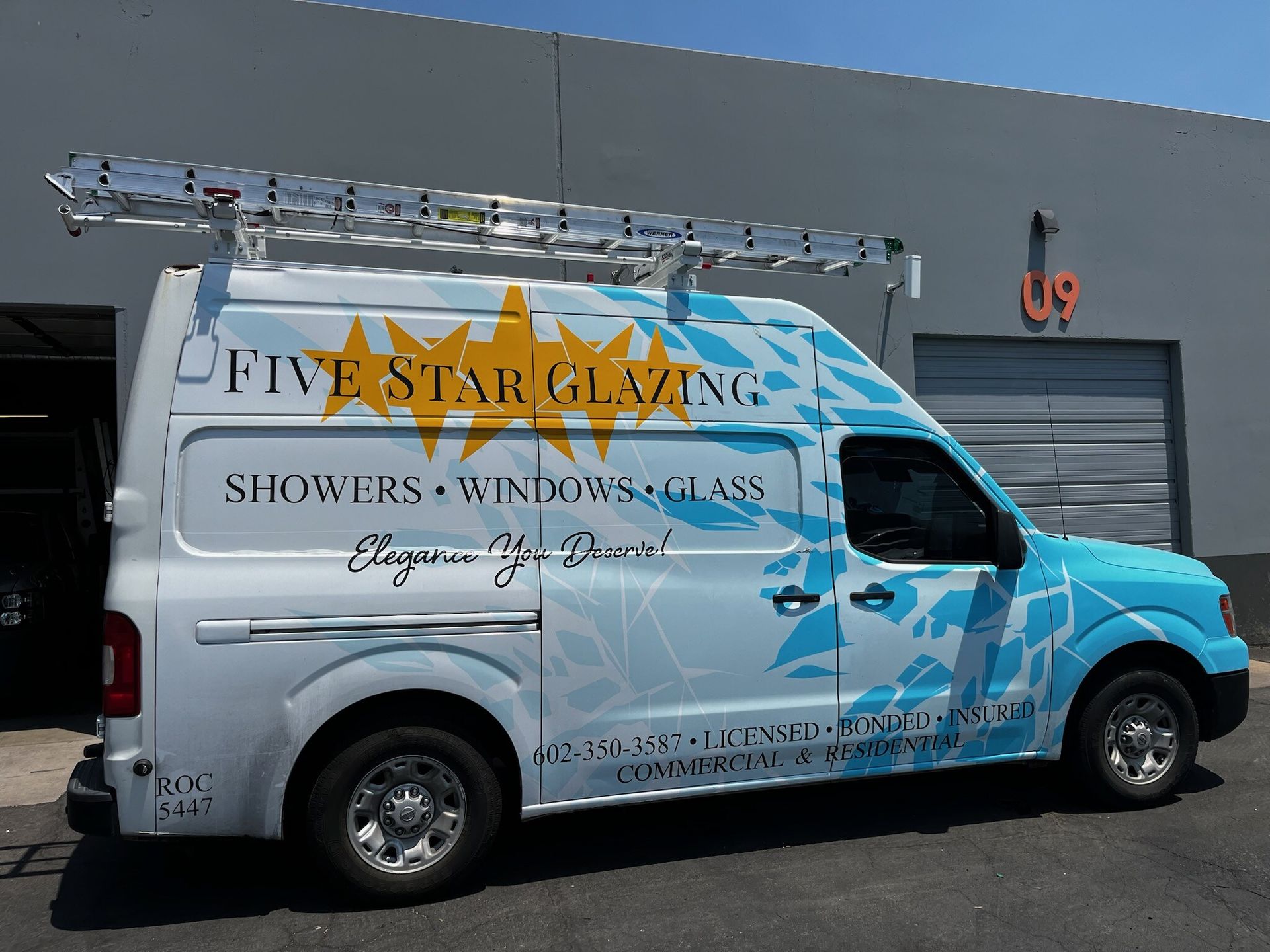 A bathroom with a bathtub and a sliding glass shower door.