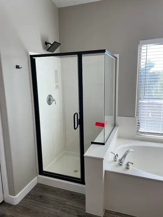 A bathroom with a walk in shower and a bathtub.