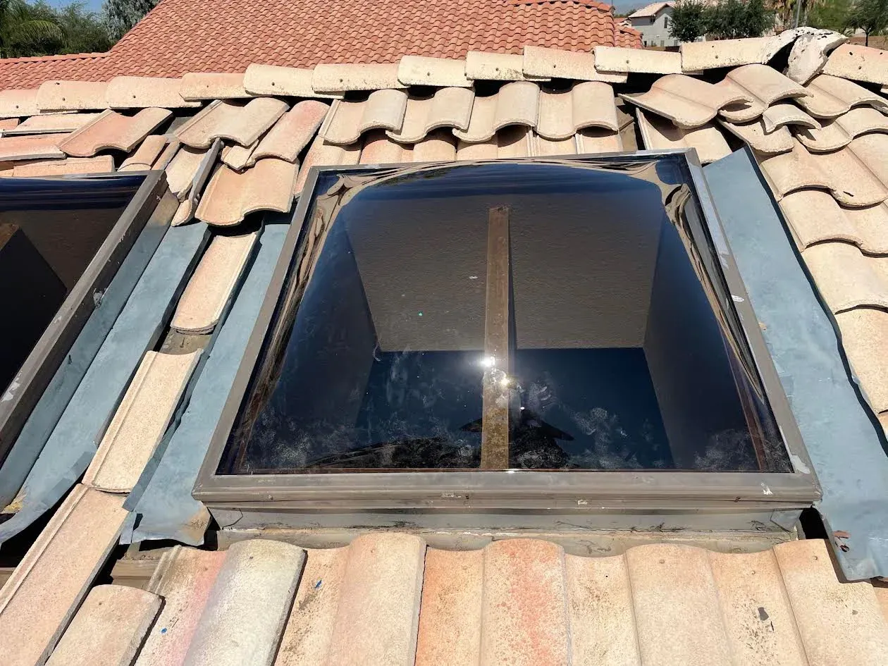 A roof with a skylight in the middle of it