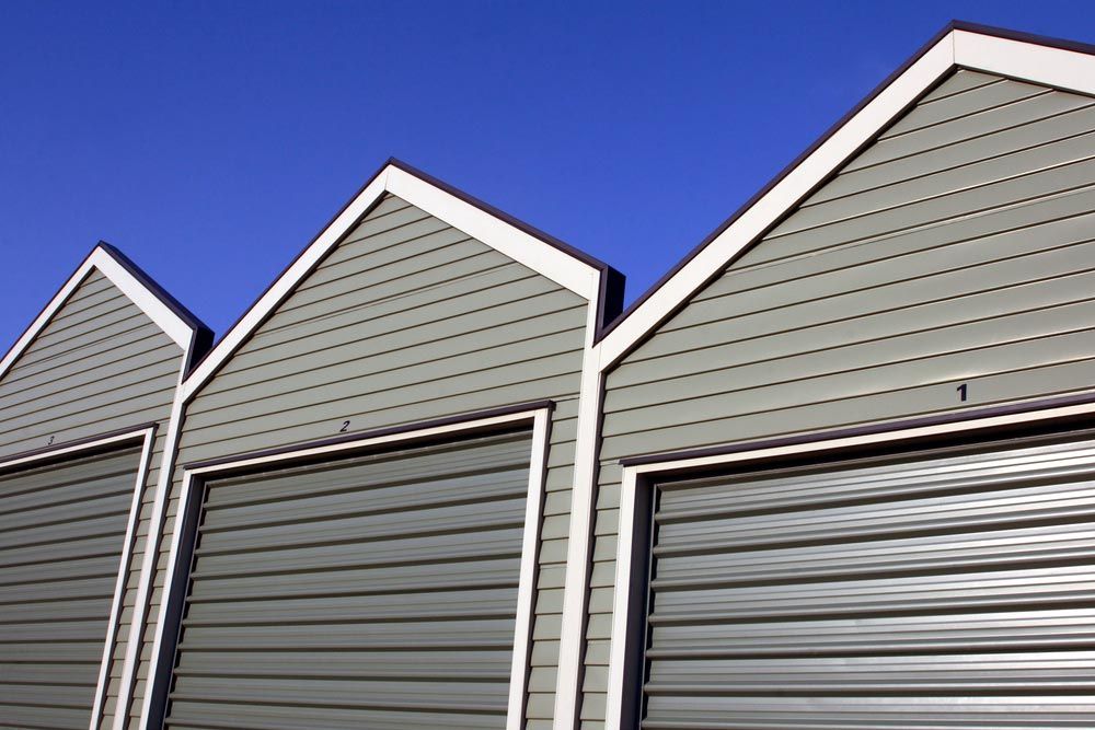 Row Of Small Grey Storage Sheds — Garages & Sheds in Nambucca Heads, NSW