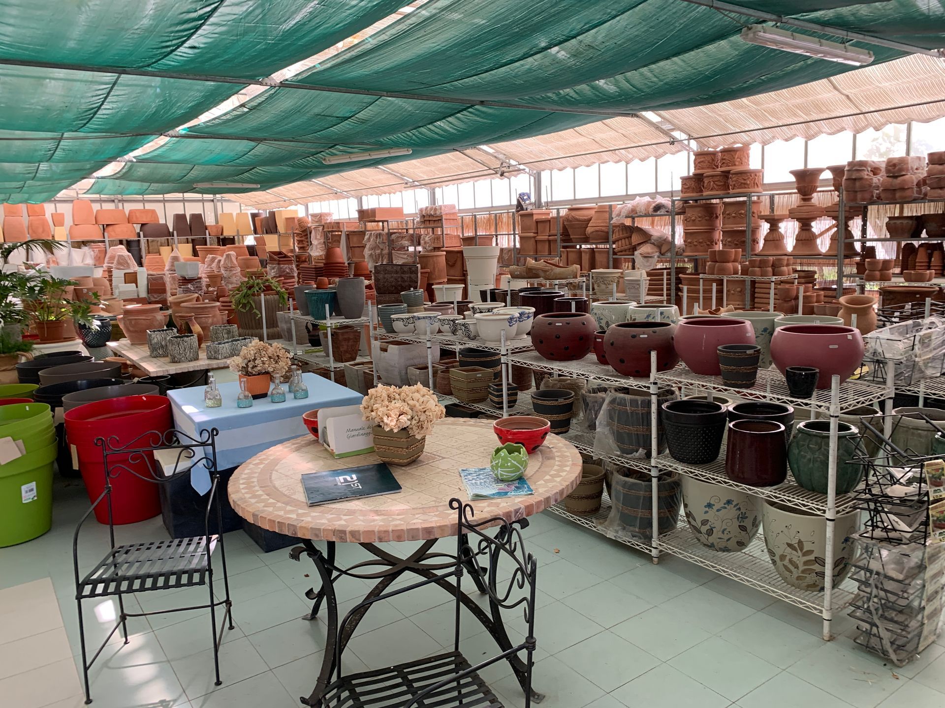 Una grande stanza piena di tante pentole e un tavolo.