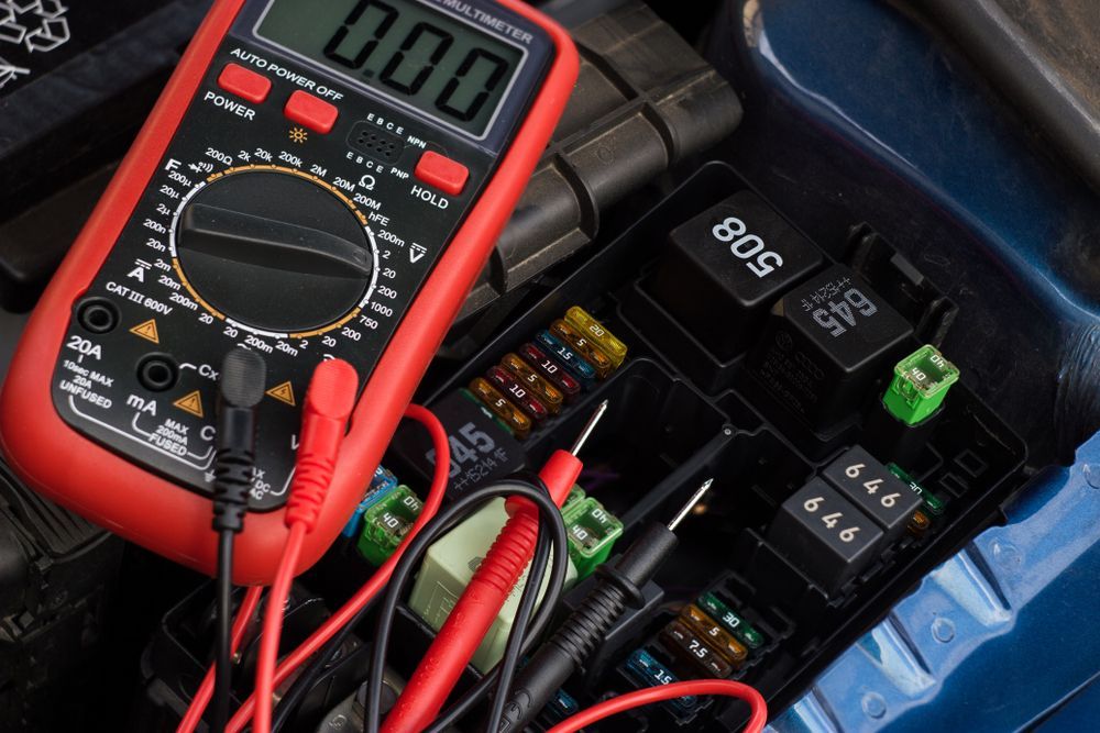 Mechanic Using Laptop and Multimeter to Diagnose Car Engine Issues — Wallsend Automotive in Maryland, NSW