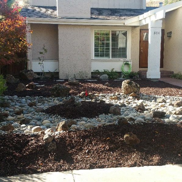A house with a lot of rocks in front of it